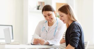 woman and medical professional going over ultrasound results