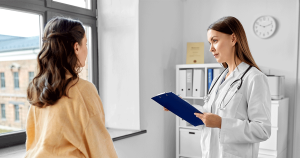 Medical Professional reviewing pregnancy test results with a woman